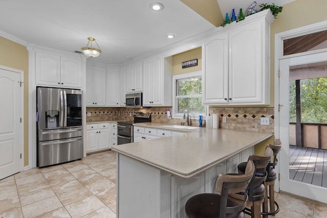 kitchen with appliances with stainless steel finishes and white cabinets