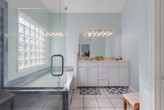 bathroom featuring a sink, a garden tub, tile patterned flooring, and a wealth of natural light