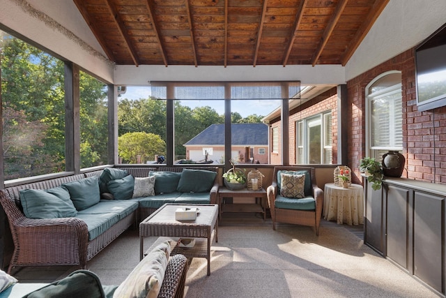 sunroom featuring vaulted ceiling with beams, wood ceiling, and a healthy amount of sunlight