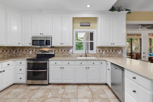 kitchen featuring light countertops, appliances with stainless steel finishes, and white cabinetry