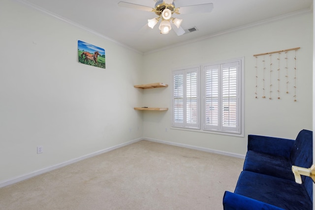 sitting room featuring crown molding, light colored carpet, visible vents, ceiling fan, and baseboards