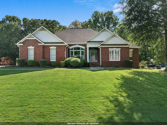 view of front of house with a front lawn and brick siding