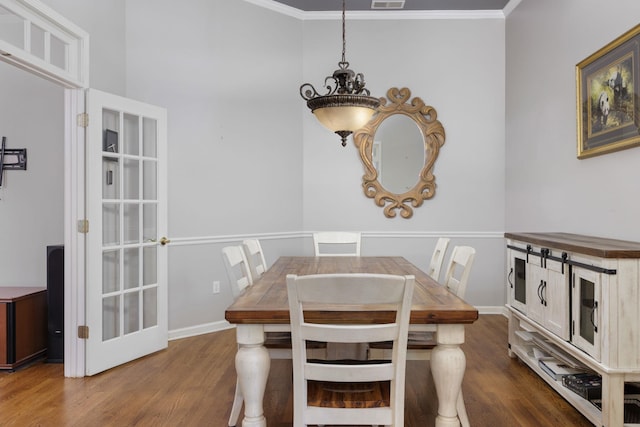 dining area with dark wood-style floors, ornamental molding, visible vents, and baseboards