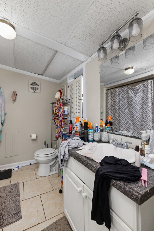 bathroom with toilet, a drop ceiling, curtained shower, tile patterned flooring, and vanity