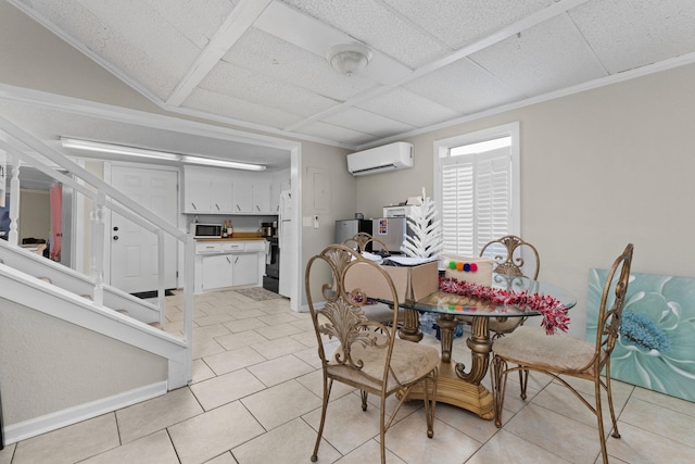 dining room featuring light tile patterned floors, an AC wall unit, a paneled ceiling, and baseboards