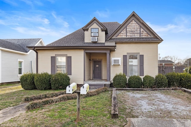 view of front of home featuring cooling unit and roof with shingles