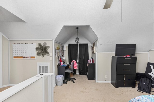 carpeted bedroom featuring lofted ceiling, a ceiling fan, visible vents, and baseboards