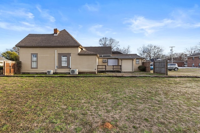 rear view of property with cooling unit, fence, a chimney, ac unit, and a lawn