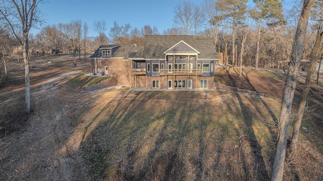 back of house featuring a wooden deck and a lawn