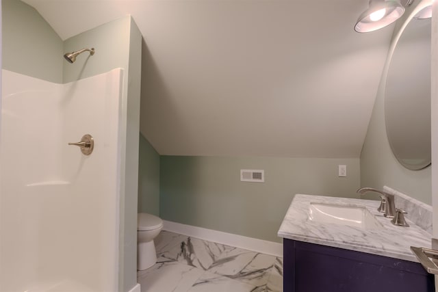 bathroom featuring vanity, vaulted ceiling, walk in shower, and toilet