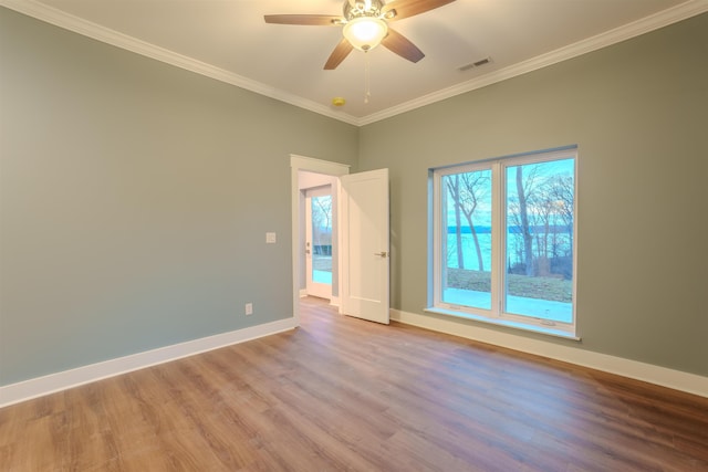 empty room featuring ornamental molding, ceiling fan, and light hardwood / wood-style floors