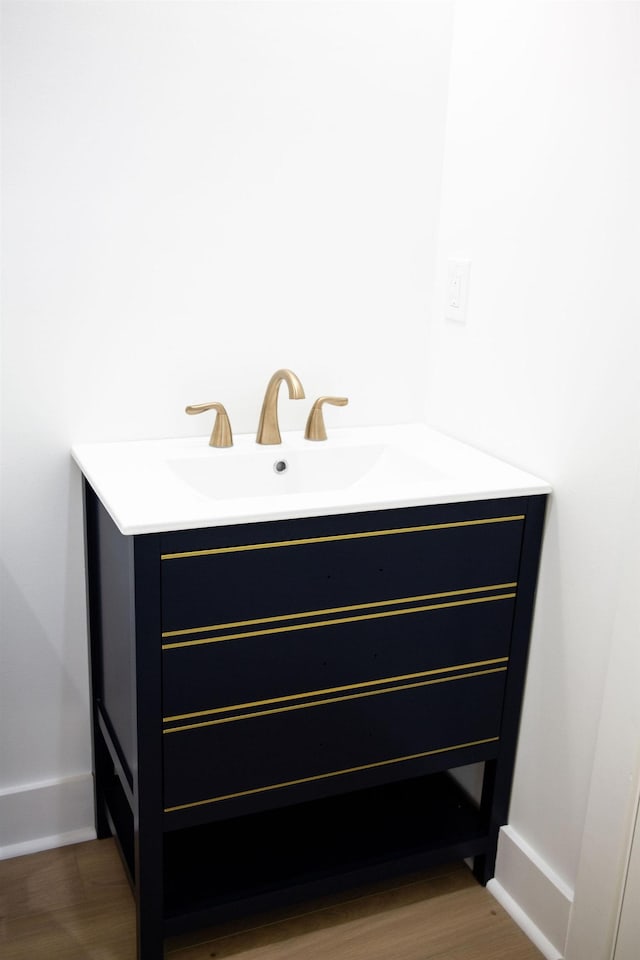 bathroom with vanity and wood-type flooring