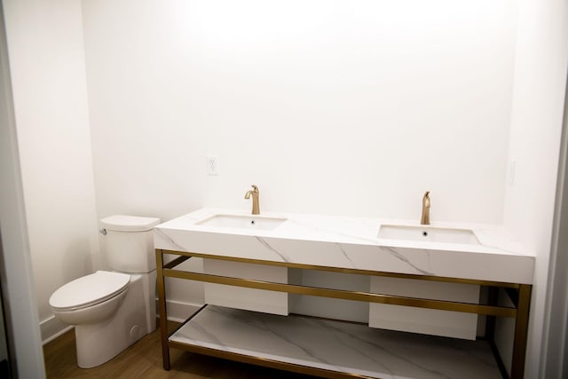 bathroom featuring hardwood / wood-style floors, vanity, and toilet