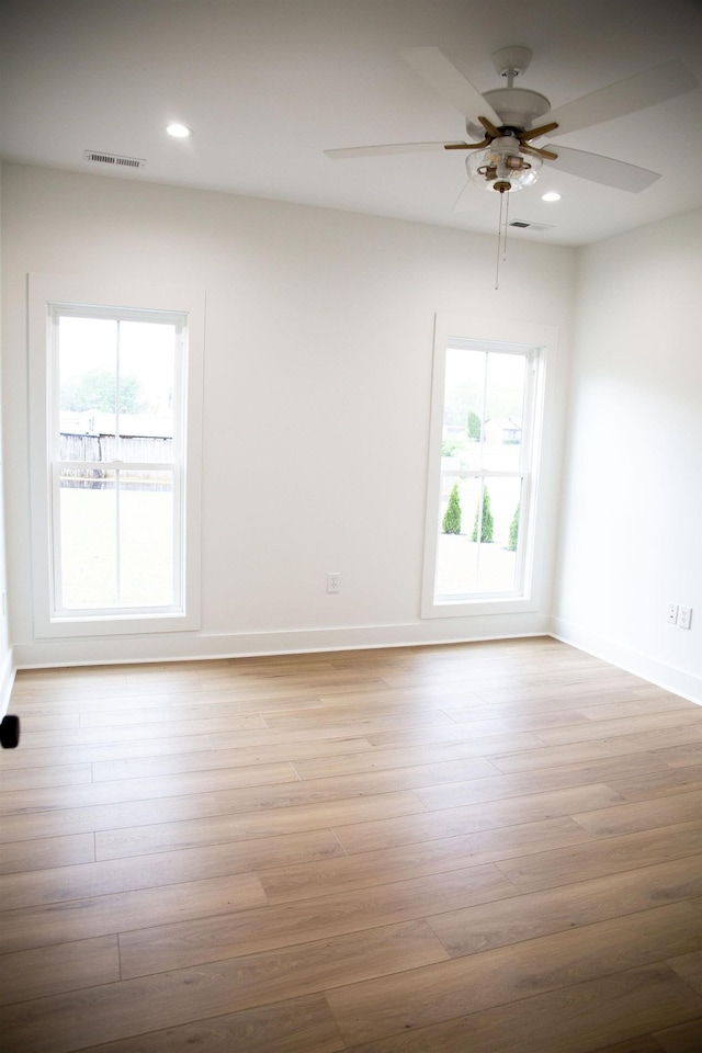 spare room featuring light hardwood / wood-style floors and a wealth of natural light