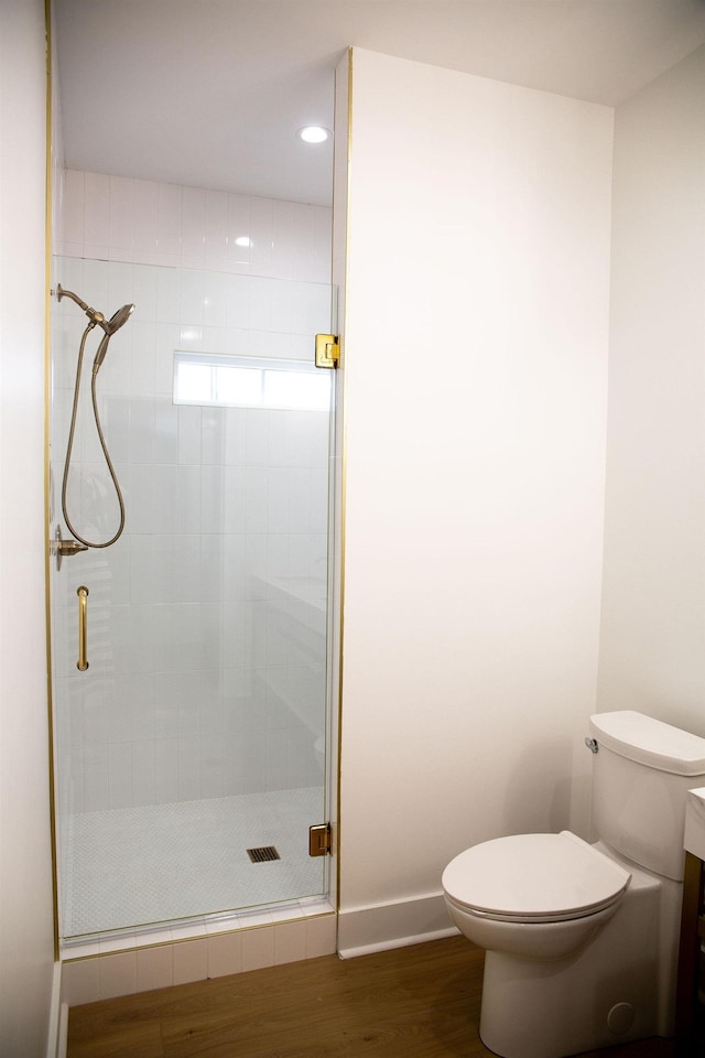 bathroom featuring vanity, toilet, wood-type flooring, and walk in shower