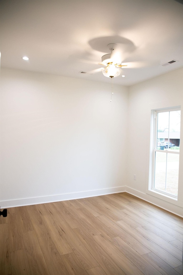 empty room featuring ceiling fan and light hardwood / wood-style flooring