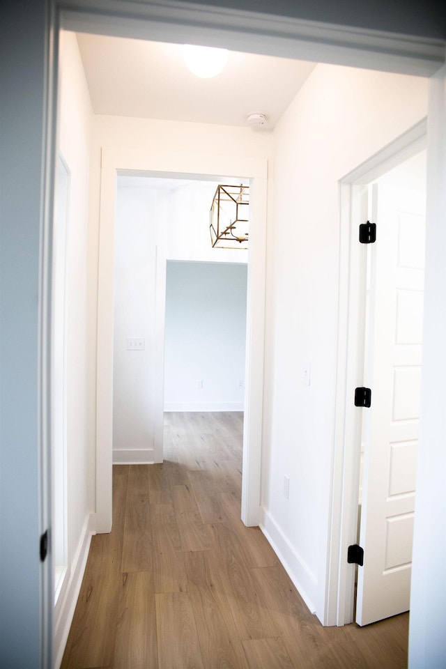 corridor with light hardwood / wood-style floors