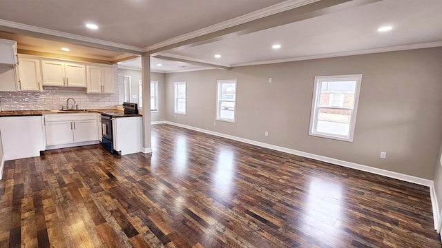 kitchen featuring tasteful backsplash, range with electric cooktop, dark wood finished floors, baseboards, and open floor plan