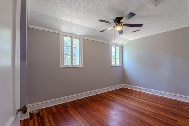 empty room with a textured ceiling, wood-type flooring, ceiling fan, baseboards, and vaulted ceiling