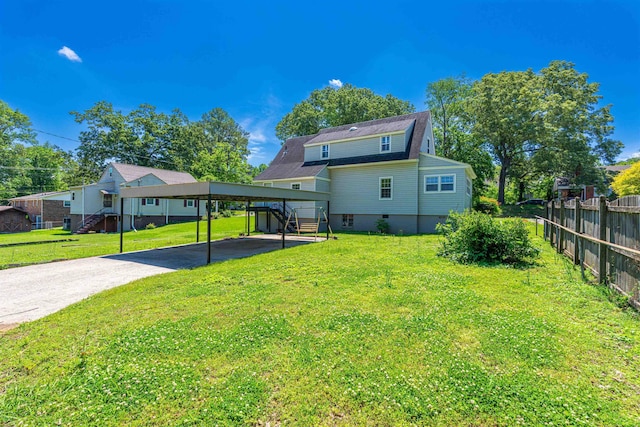rear view of house with stairs, driveway, and a carport