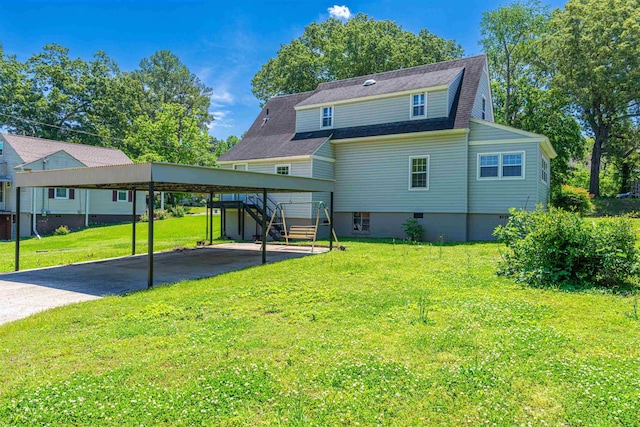rear view of house featuring a yard, asphalt driveway, stairway, and roof with shingles
