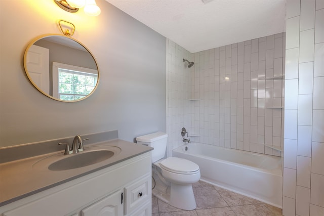 full bathroom with tile patterned floors, toilet, bathtub / shower combination, vanity, and a textured ceiling