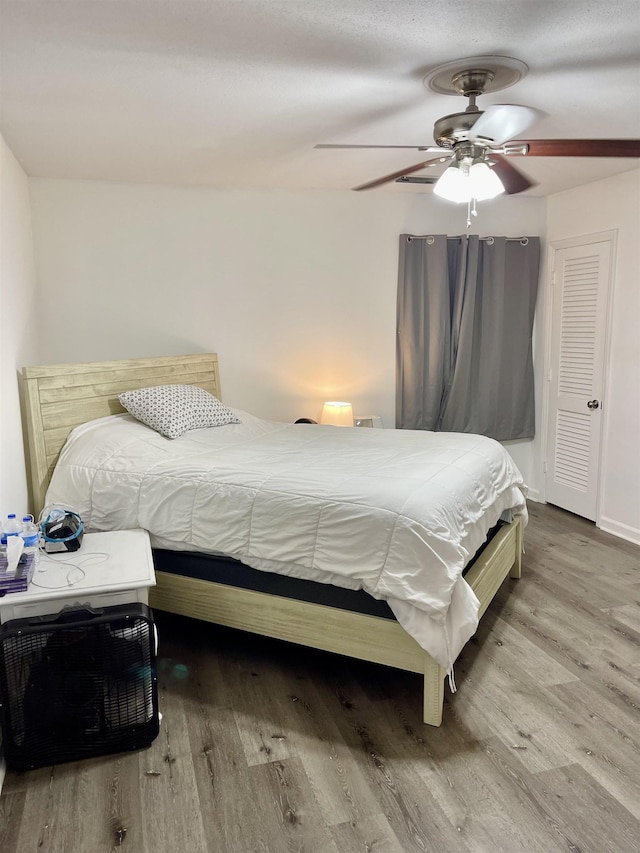  - bedroom featuring wood finished floors and a ceiling fan