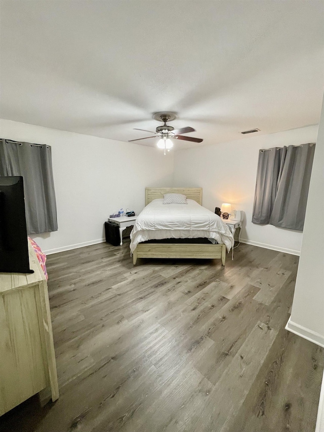  - bedroom featuring wood finished floors and a ceiling fan