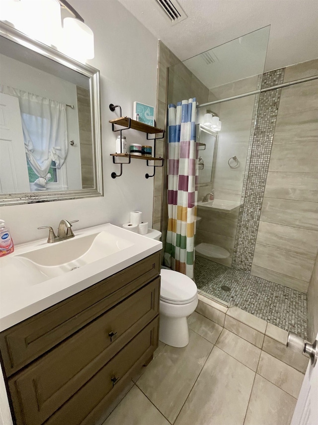  - bathroom featuring a tile shower, tile patterned floors, and vanity