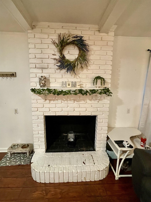  - detailed view of crown molding, a fireplace, and wood finished floors