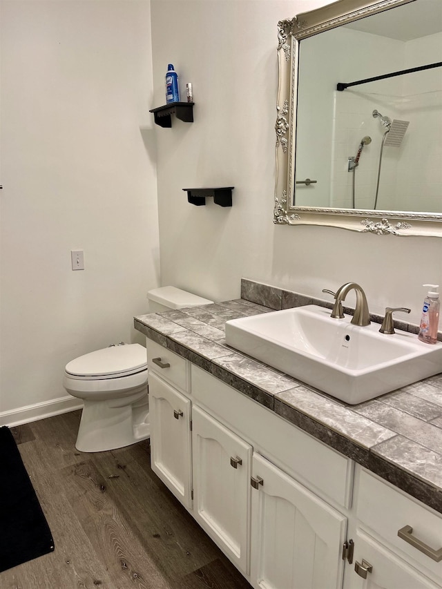  - full bath with wood finished floors, vanity, and a shower
