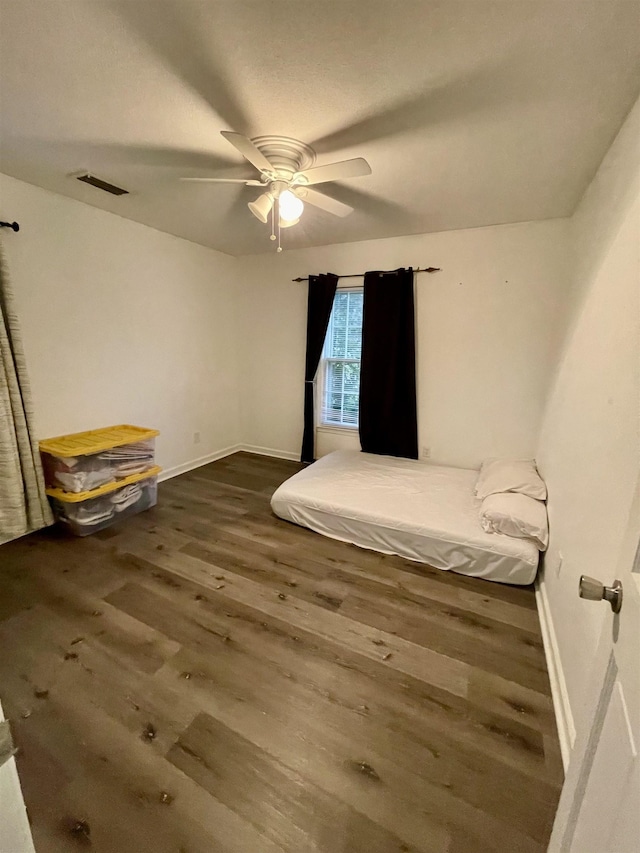  - unfurnished bedroom with wood finished floors and ceiling fan