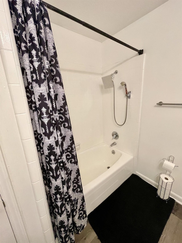  - bathroom featuring shower / bath combo with shower curtain and wood finished floors