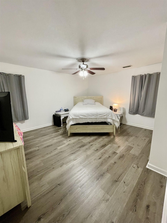  - bedroom featuring wood finished floors and ceiling fan