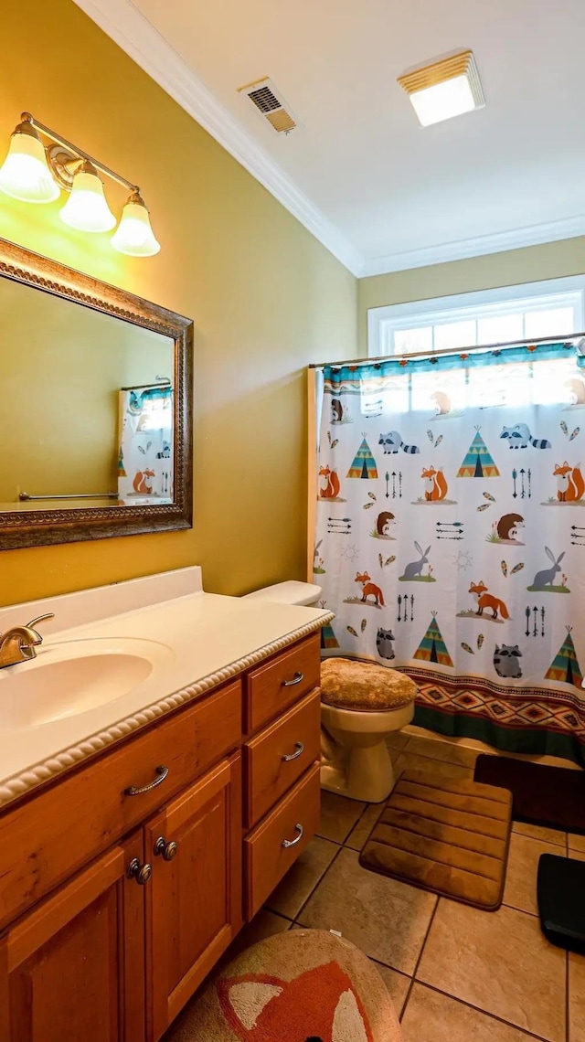 bathroom featuring toilet, vanity, visible vents, tile patterned floors, and crown molding