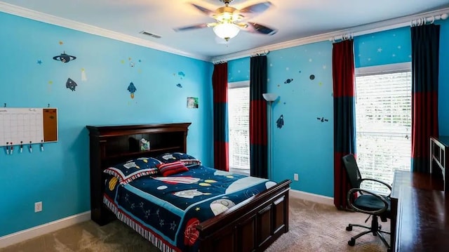 carpeted bedroom with ornamental molding, a ceiling fan, visible vents, and baseboards