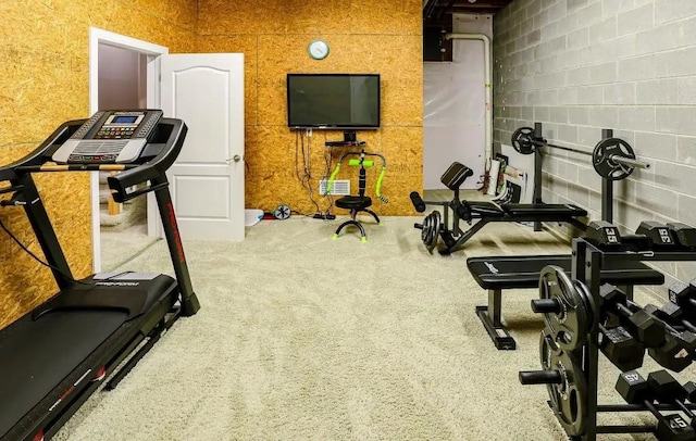 workout area with concrete block wall