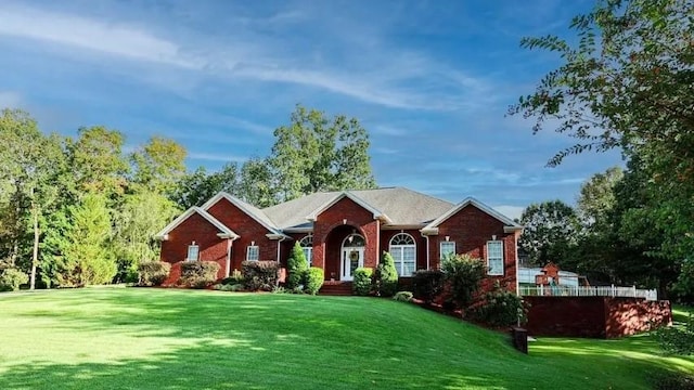 ranch-style home with a front lawn and brick siding