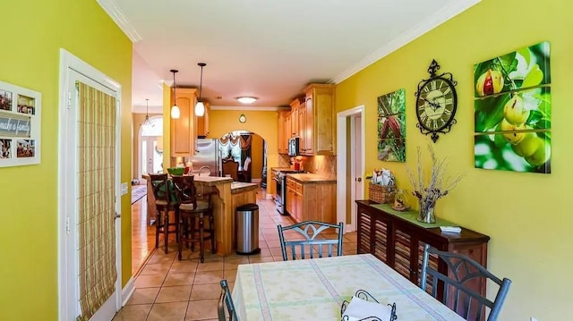 dining area with light tile patterned floors, french doors, ornamental molding, and baseboards