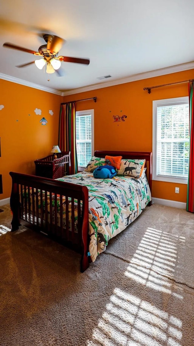 bedroom featuring ornamental molding, visible vents, and multiple windows