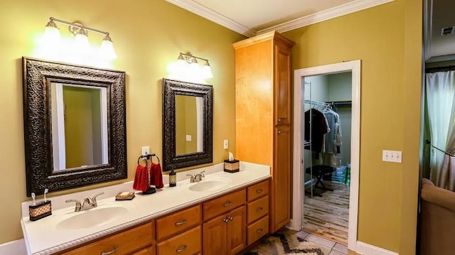 full bath featuring crown molding, visible vents, a sink, and double vanity