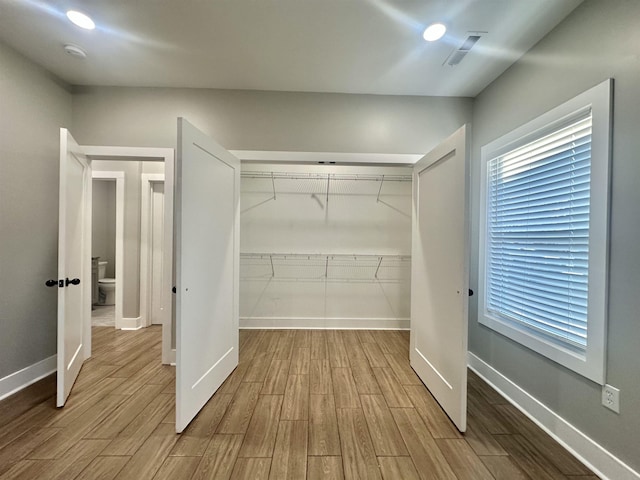 spacious closet with light wood-style flooring