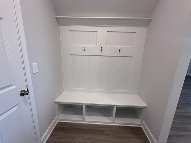 mudroom featuring dark wood-style flooring and baseboards