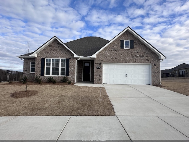 view of front of house featuring a garage, brick siding, driveway, and fence