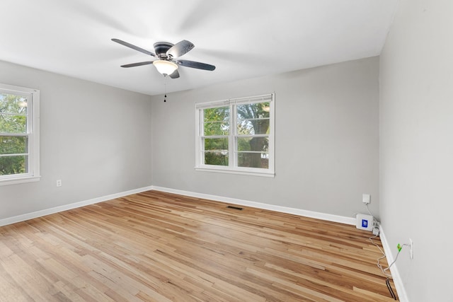 spare room with light wood-type flooring and ceiling fan