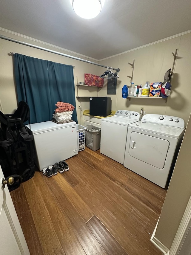 laundry room with washer and clothes dryer, hardwood / wood-style floors, and ornamental molding