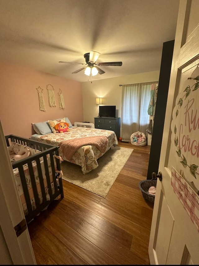 bedroom featuring ceiling fan and dark hardwood / wood-style floors