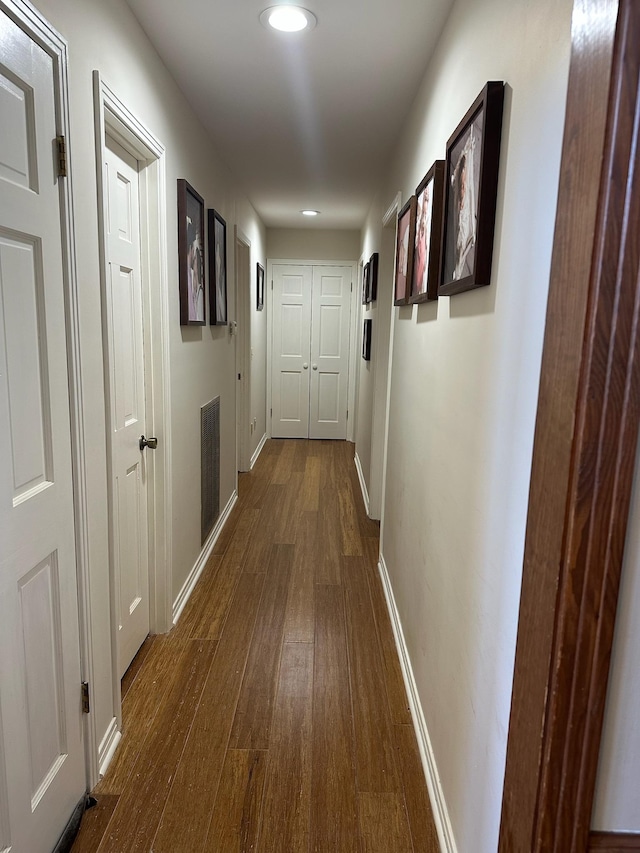 corridor featuring dark hardwood / wood-style floors