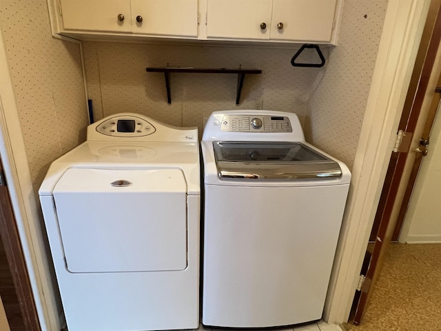 laundry room with cabinets and separate washer and dryer