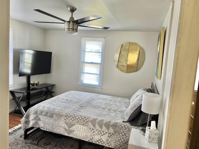 bedroom with hardwood / wood-style floors and ceiling fan